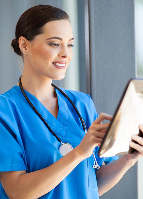 female nurse using tablet computer in hospital